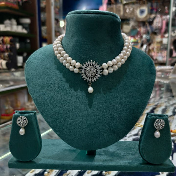 pearl necklace set with a pendant and matching earrings.